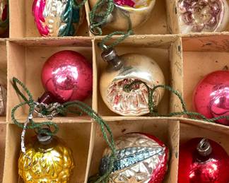 Detail of lovely antique glass Christmas tree ornaments in gold, red, and pink