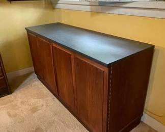 3/4 view of Mid-Century Modern slate top rosewood two door credenza, measuring 48" wide x 16 1/4" deep x 25" high