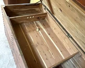 Interior view with shelf insert of vintage "Guaranteed Tennessee Aromatic Red Cedar" JRC trunk