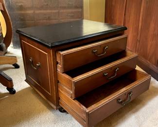 Dark wood topped 3-drawer wood chest on wheels and side handles, measures 16" wide x 22" deep x 17" high