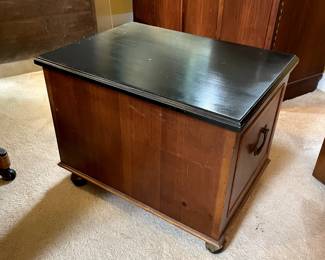Back view of dark wood topped 3-drawer wood chest on wheels and side handles, measures 16" wide x 22" deep x 17" high