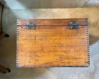 Exterior hinge detail of almost-square vintage wood storage chest with corners beautifully seamed with a box joint