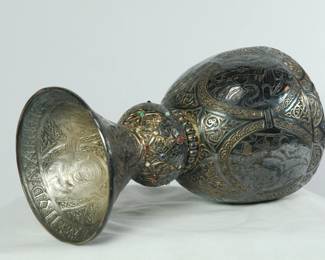 3/4 side view of the replica of Replica of The Tassilo Chalice: an 8th century bronze chalice gilded with silver and gold, located in Kremsmuenster Abbey in Austria.
