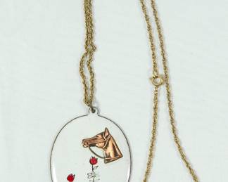 Cool enamel pendant with a copper horse head on white background with small red flowers. Pendant is on a brass rope chain.