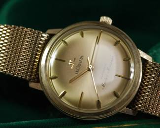 Detail of Le Coultre Master Mariner gold wrist watch with gold mesh band still in original green velvet display box. Band reads Kestenmade 10K G.F. USA