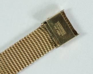 Band stamp detail of Le Coultre Master Mariner gold wrist watch with gold mesh band still in original green velvet display box. Band reads Kestenmade 10K G.F. USA