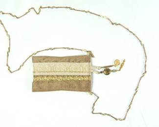 Small crossbody neutral tone fabric purse with beautiful trim detail, attached charms and a delicate jewelry chain strap.