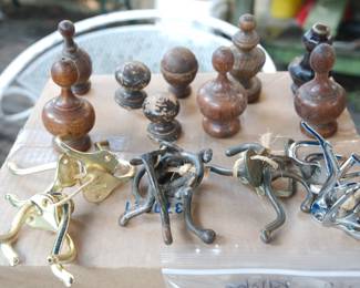 Various vintage hat and coat wall hooks in brass and iron and wooden finials