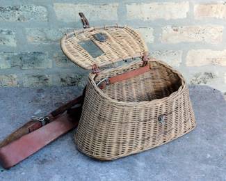 View of Vintage wicker fishing creel or basket with leather straps and closure open