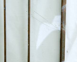 Detail of crack on a small section on the right of first Prairie School style stained glass window panel: clear glass with amber, gold, green, blue and red details, each panel measuring 10 3/8" wide x 20 3/8" high