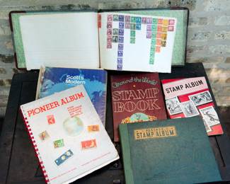 Several postage stamp albums, postage stamp collection books including "The New Pioneer Album, "Postage Stamp Album", The Adventurer Stamp Album", "Around the World Stamp Book", and "Scott's Modern Stamp Album"