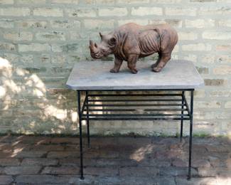 Large rhinoceros figurine, shown on table for scale