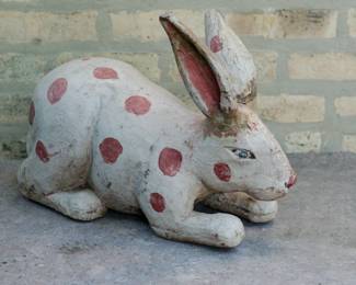 Side view of large carved wooden folk art rabbit figurine