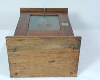 Bottom view of "I'll Match You for One Cent" antique safety match vending machine