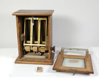 Detail showing interior of "I'll Match You for One Cent" antique safety match vending machine with front removed