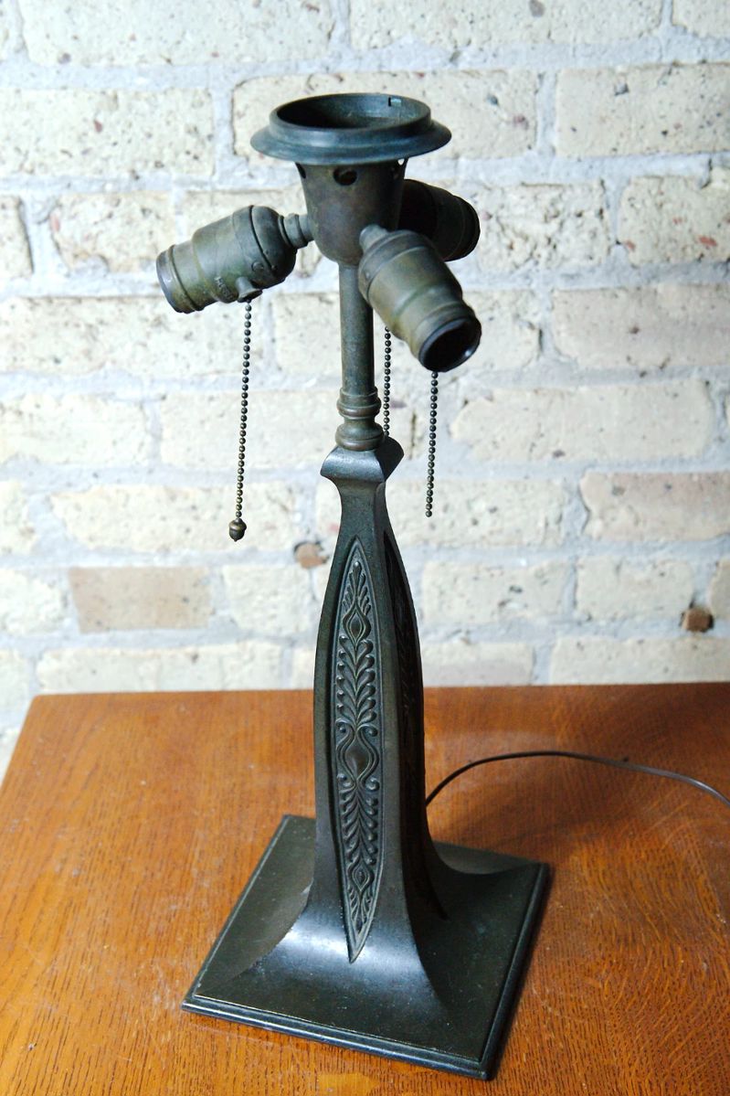 Detail of bronze lamp, without shade showing the socket cluster and the flange the shade rests upon
