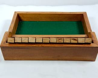 Back view of vintage wooden "Shut the Box" dice game