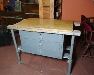 Vintage steel industrial three-drawer worktable with a wood top