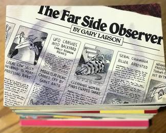 Cover of stack of collection of books of comic strips including Garfield by Jim Davies, The Far Side by Gary Larson