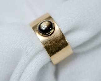 Cigar band style ring with a black star sapphire, 14K yellow gold, size 8 1/2