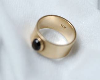 Interior view of band showing 14K stamp of 14K yellow gold cigar band style ring with a black star sapphire, size 8 1/2