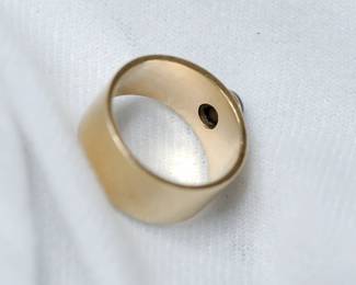 Interior view of the setting of 14K yellow gold cigar band style ring with a black star sapphire, size 8 1/2