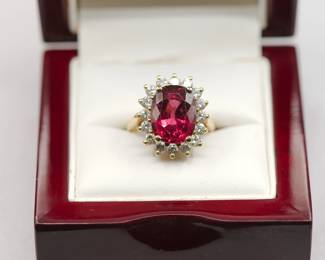 Shown in display box, 18K yellow gold ring with 1 carat single cut diamonds and an approximately 6.5 carat tourmaline, size 6