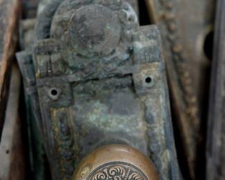 Another view of the collection of antique bronze door hardware from a Cook County building, Seal of Cook County on the plates