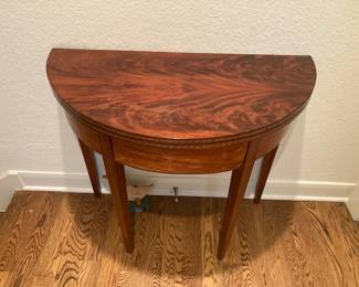 late 18th century mahogany demi lune table. Has folding top to make this 34 inches in diameter