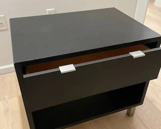 Ebony MDF with stainless steel base and aluminum drawer pulls. Retails new for $750: https://www.roomandboard.com/catalog/bedroom/nightstands/copenhagen-nightstands. -- in good condition but shows a little use.