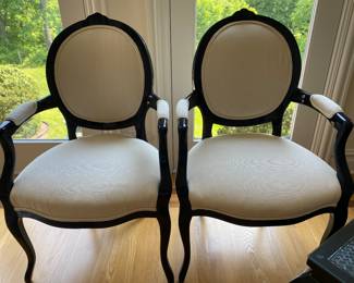 A pair of open upholstered armchairs.