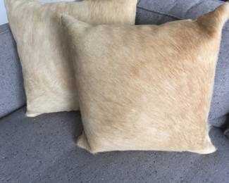 Pair of pony-haired, down-filled throw pillows. Dimensions: 17' x 17' square. $50 each.
