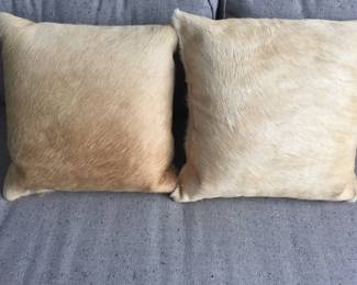 Pair of pony-haired, down-filled throw pillows. Dimensions: 17' x 17' square. $50 each.