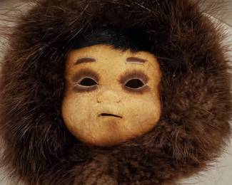 Alaskan tiny mask with fur surrounding it