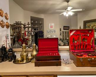 The 144 piece James is solid bronze and wood. It’s a total vintage set! 
The set next to it is a beautiful exclusive Towle silver shield strips set. Beautiful and does not turn colors.
The brass pieces came from India and they are timeless pieces with out turning colors too.
The next set which is an oriental set of vases and tea cups was acquired on a trip to Japan abd are pieces of art as you can use it to sip some great tea. 