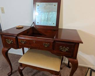 Very unique vintage makeup table with mirror and bench.