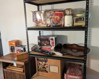 Small appliances and misc. Many with original boxes.  Items include rice maker, blenders, tea pots, thermos, hot water dispensers, serving ware and cutlery.