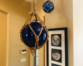 Hanging art- blue globes, and lunar black framed photography art.