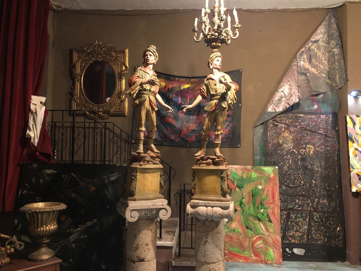Pair of figural torchiere lamps are plastic! Columns are formed stone.