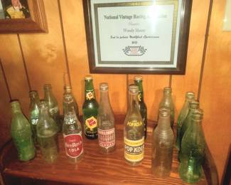 Vintage drink bottles including Red Rock Cola, Pop Kola Williams, Sun Drop, Coca Cola, & more