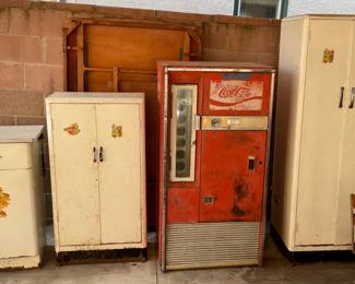 Vintage Coke machine.  Metal cabinets.