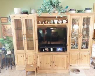 pine entertainment center with matching lighted curio cabinets