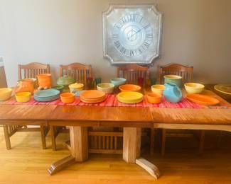 Fiesta, ware, dinner, plates, serving bowls, platters, pitchers. Vintage, pottery, bowls. Tin wall clock. Solid wood dining table extends to 8’6 when both leafs are used.