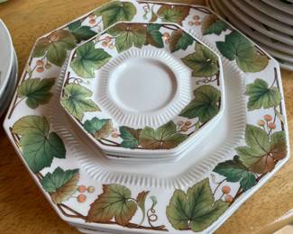 Set of seven plates and four saucers by Nikko, “Woodlands” pattern.