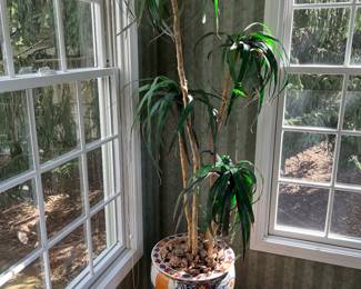 Ceramic planter with wood stand and artificial plant, by The Bombay Company.