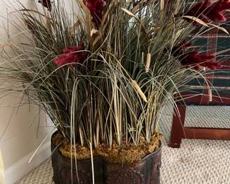 Artificial plant display in metal planter.