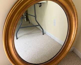 Oval wall mirror by J.A. Olson Co.