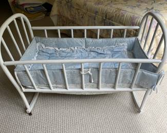 Vintage wood baby cradle with bedding.