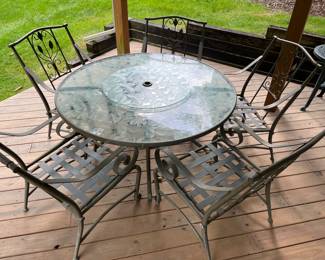 Metal/glass patio table with five chairs.