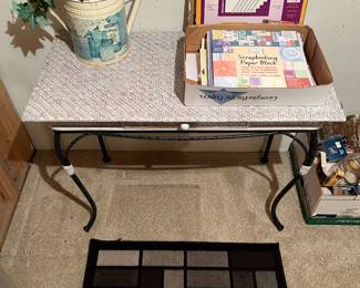 Wicker table with metal base; scrapbooking paper.